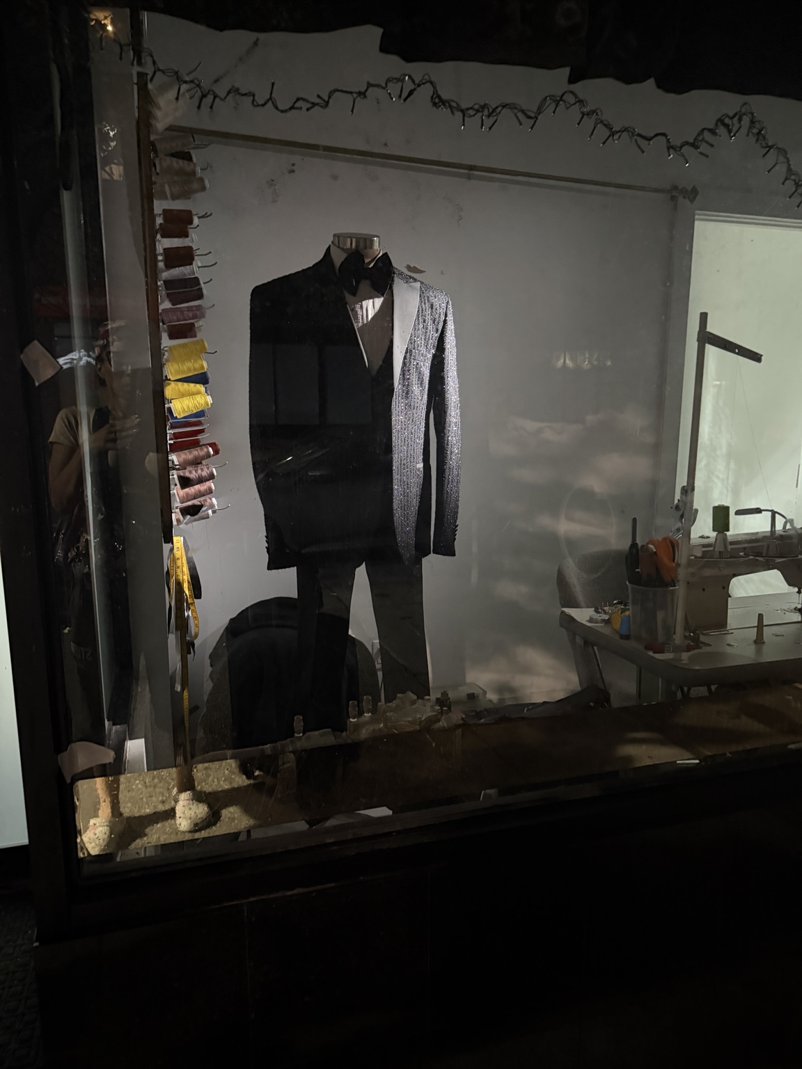 Custom black and silver tuxedo displayed in the tailoring workroom